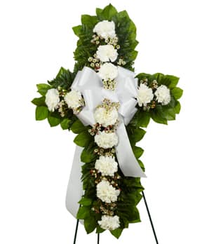 White floral standing cross with ribbon on an easel