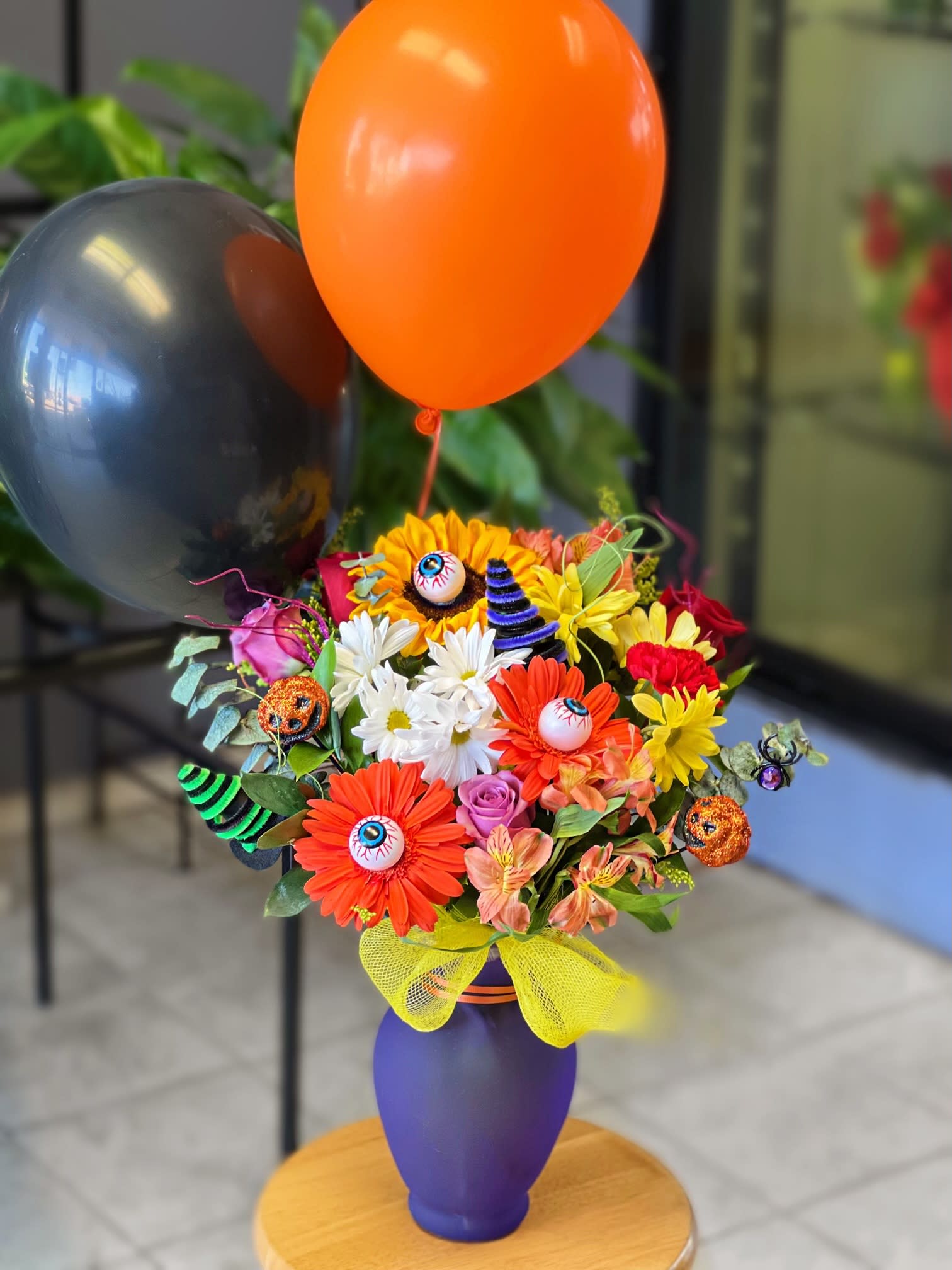 Halloween bouquet with balloons in a purple vase
