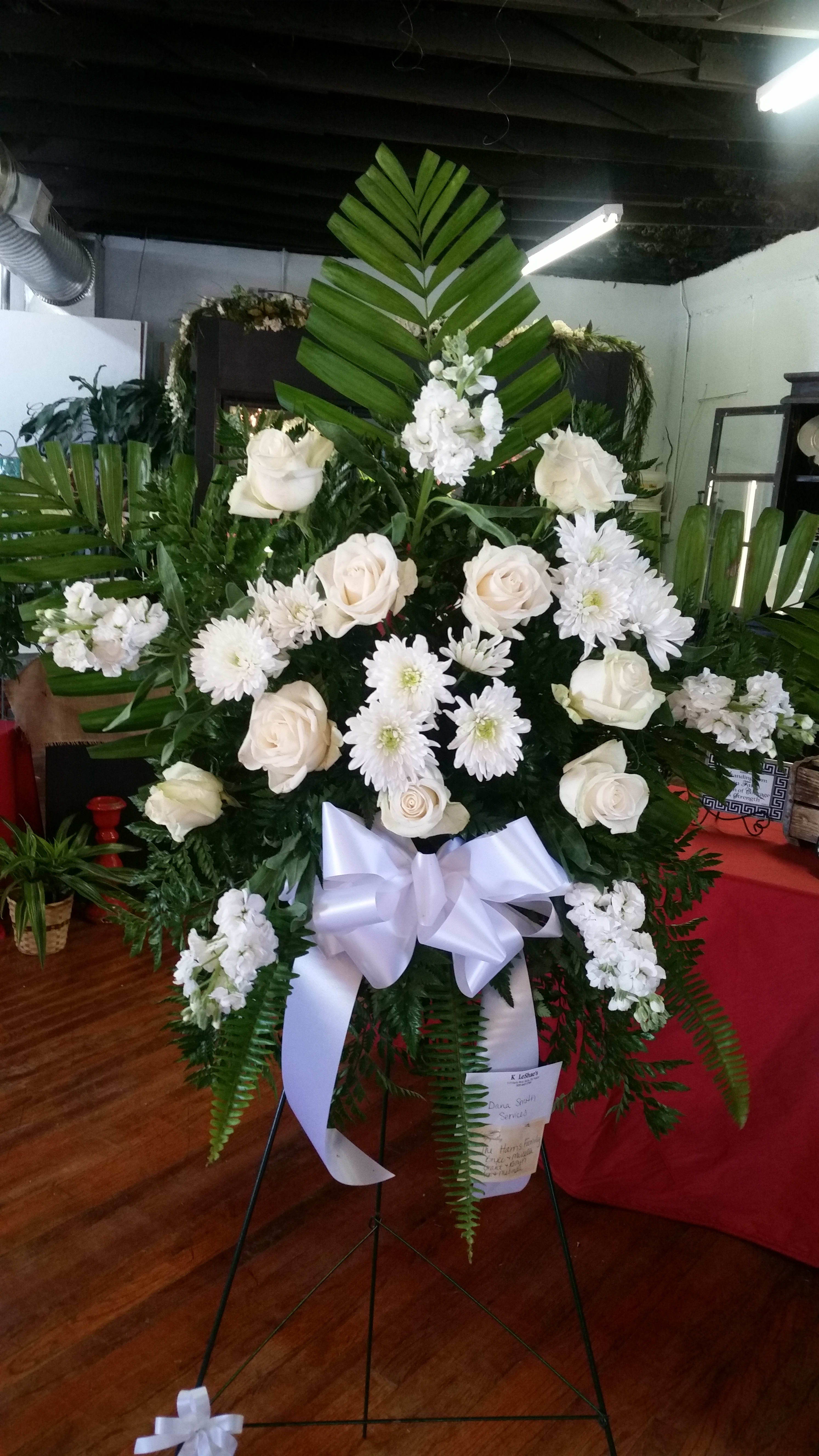 White rose and chrysanthemum standing spray with a white ribbon bow