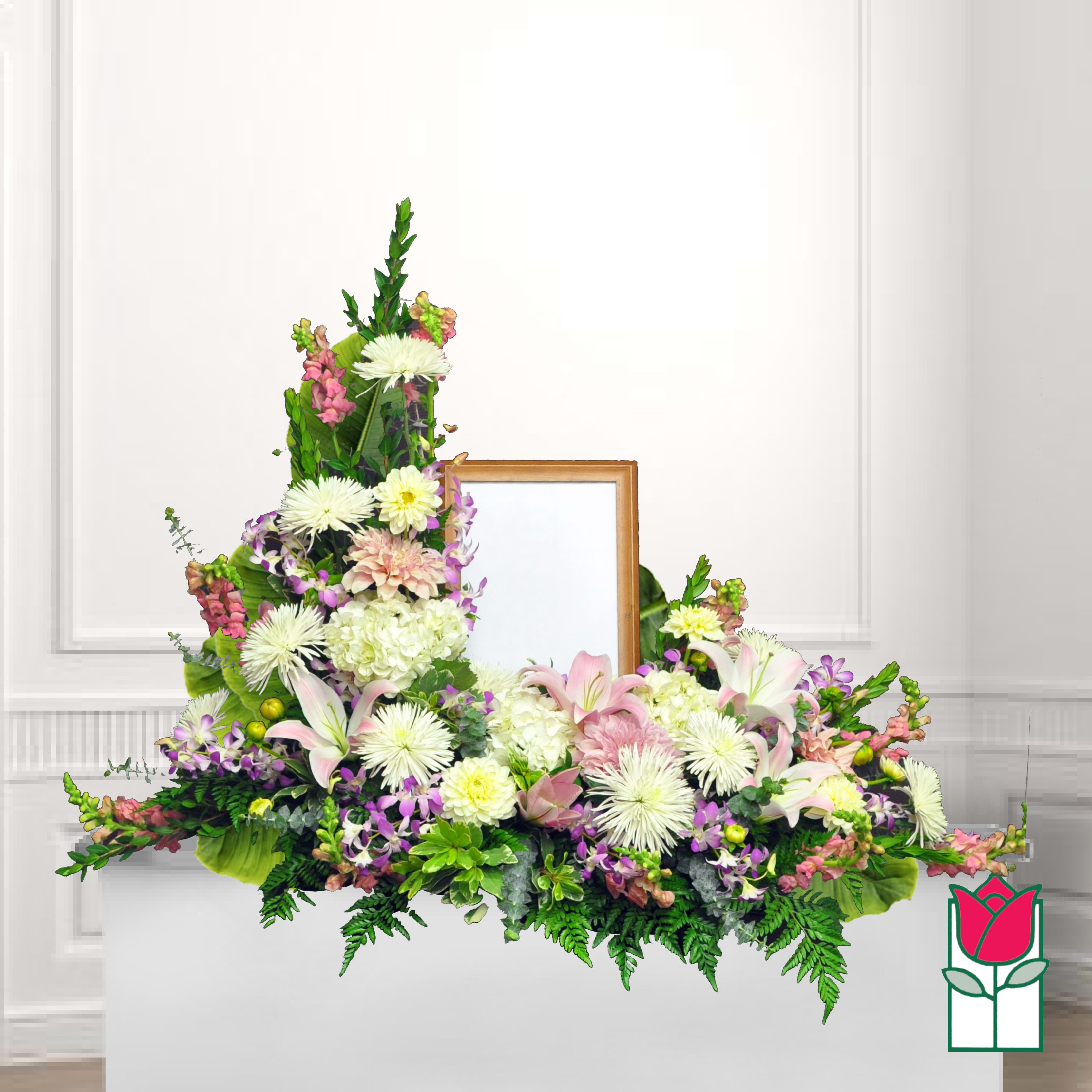 Large floral funeral spray with lilies, chrysanthemums, and pink blooms