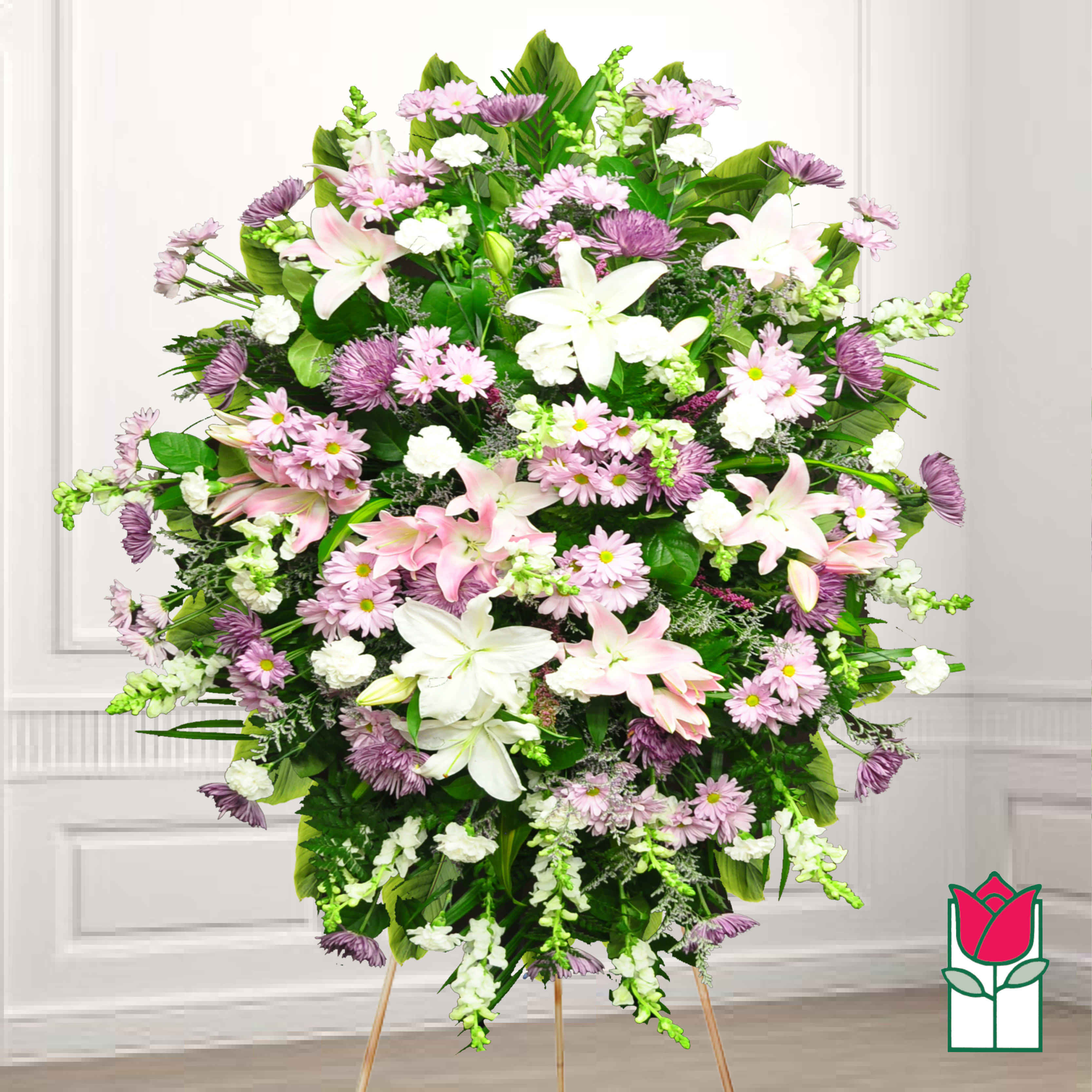Large standing spray of pink and white flowers on an easel
