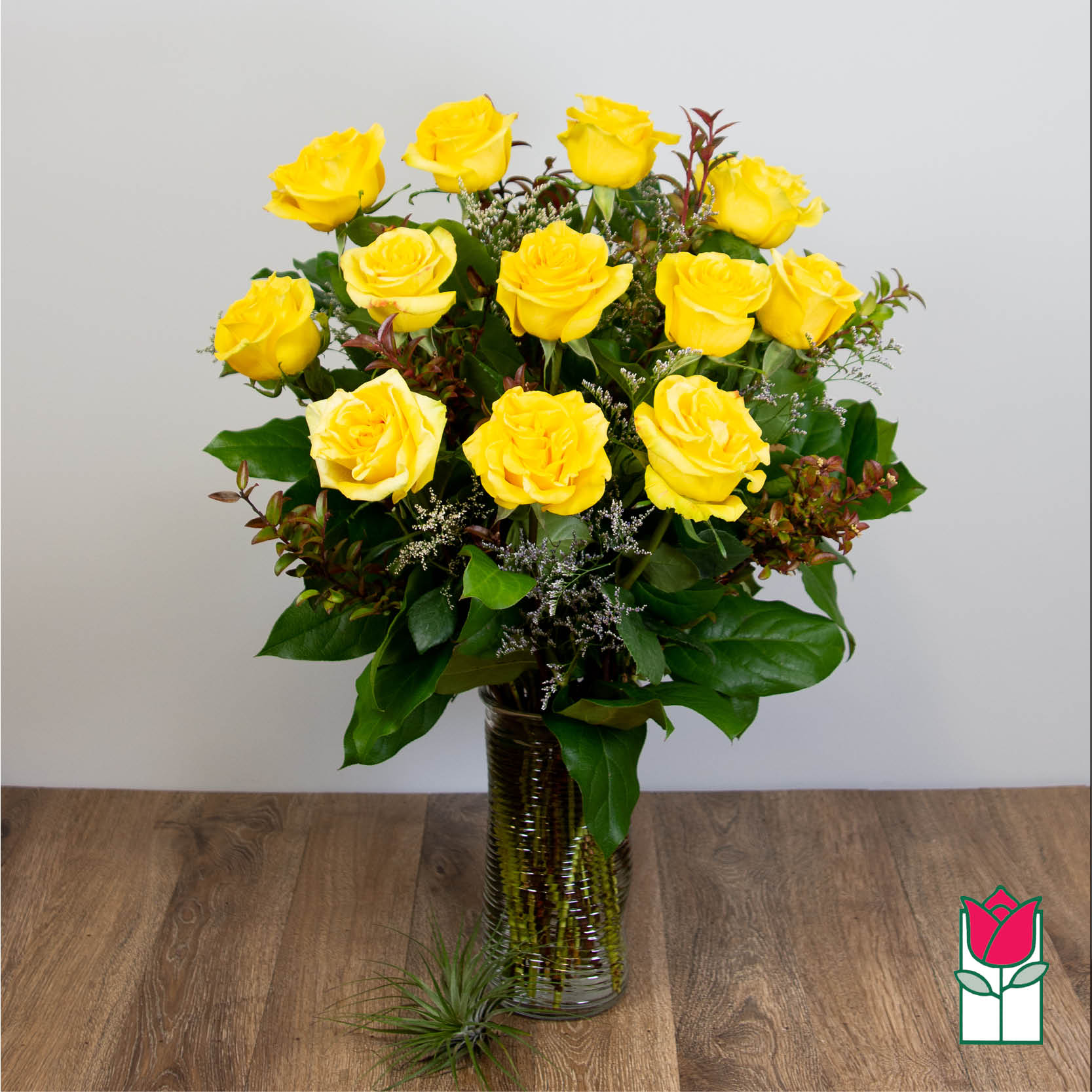Yellow roses arranged in a clear glass vase