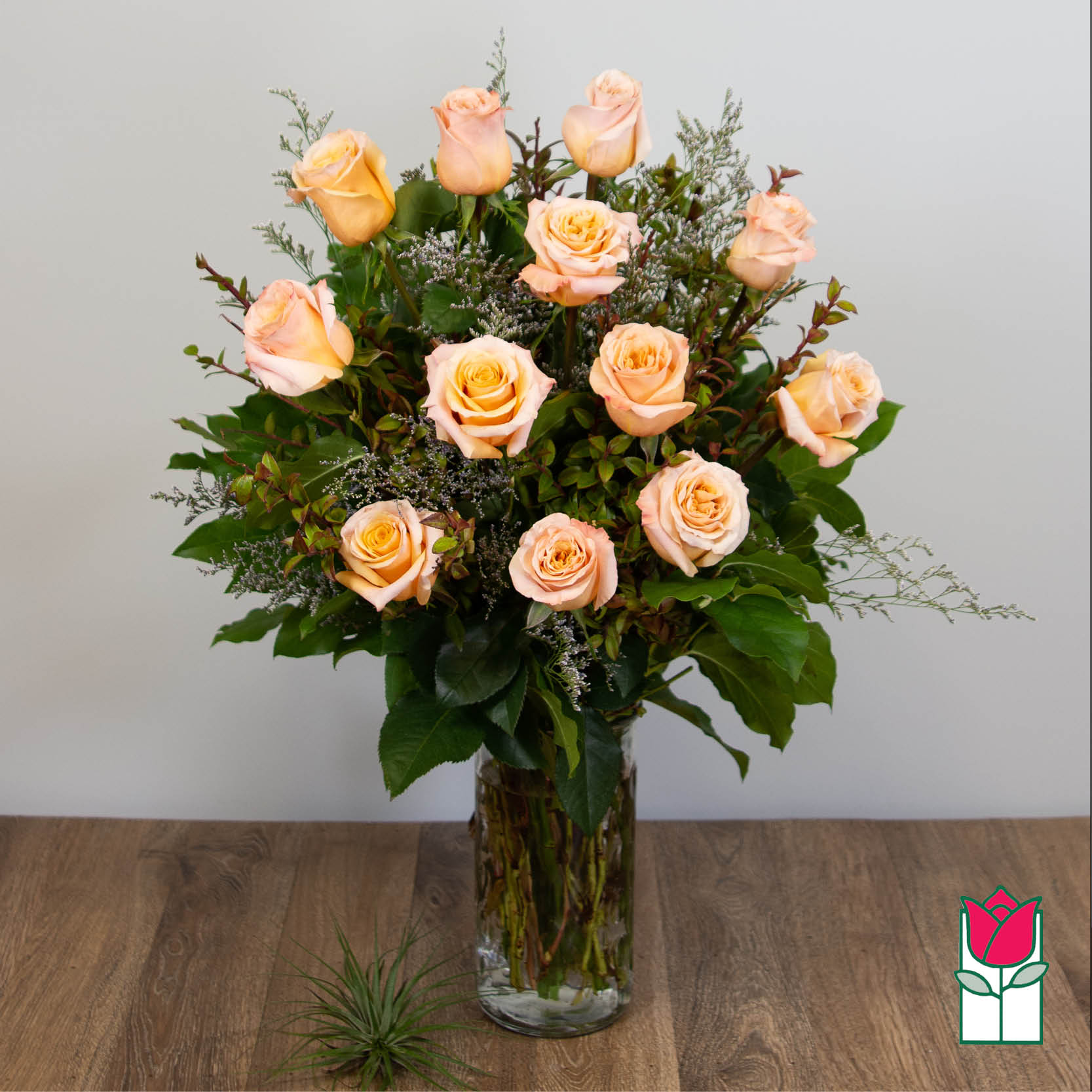Peach roses arranged in a clear glass vase