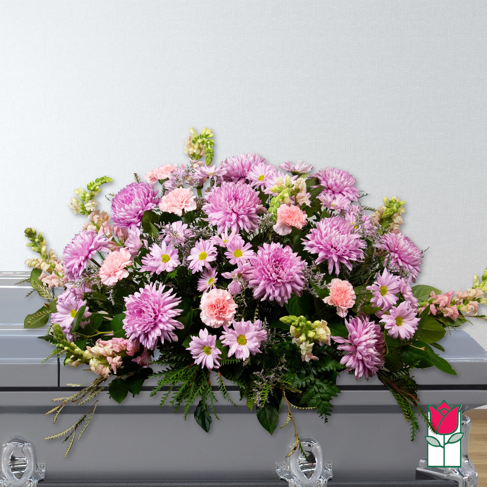 Pink and lavender floral casket spray with daisies and carnations