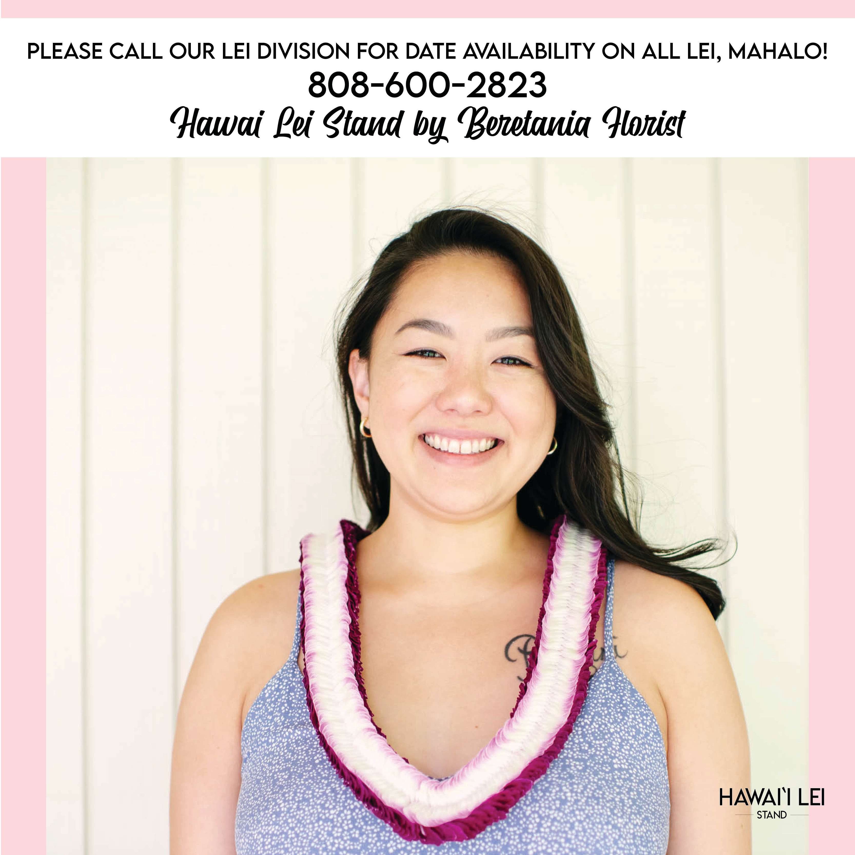 Woman wearing a white and magenta double-strand flower lei around her neck.