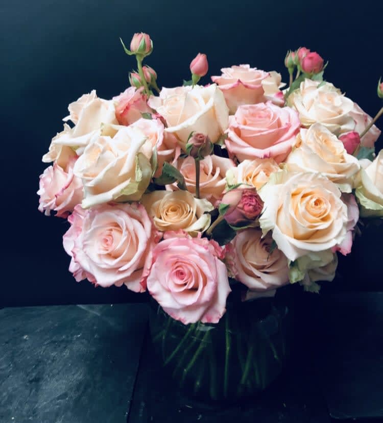 Bouquet of pink and cream roses in a glass vase