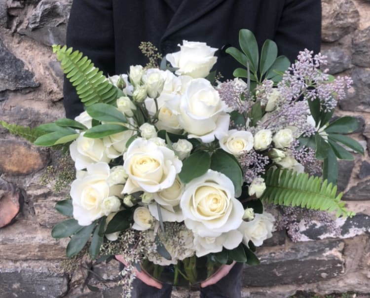 Bouquet of white roses with greenery and lavender filler