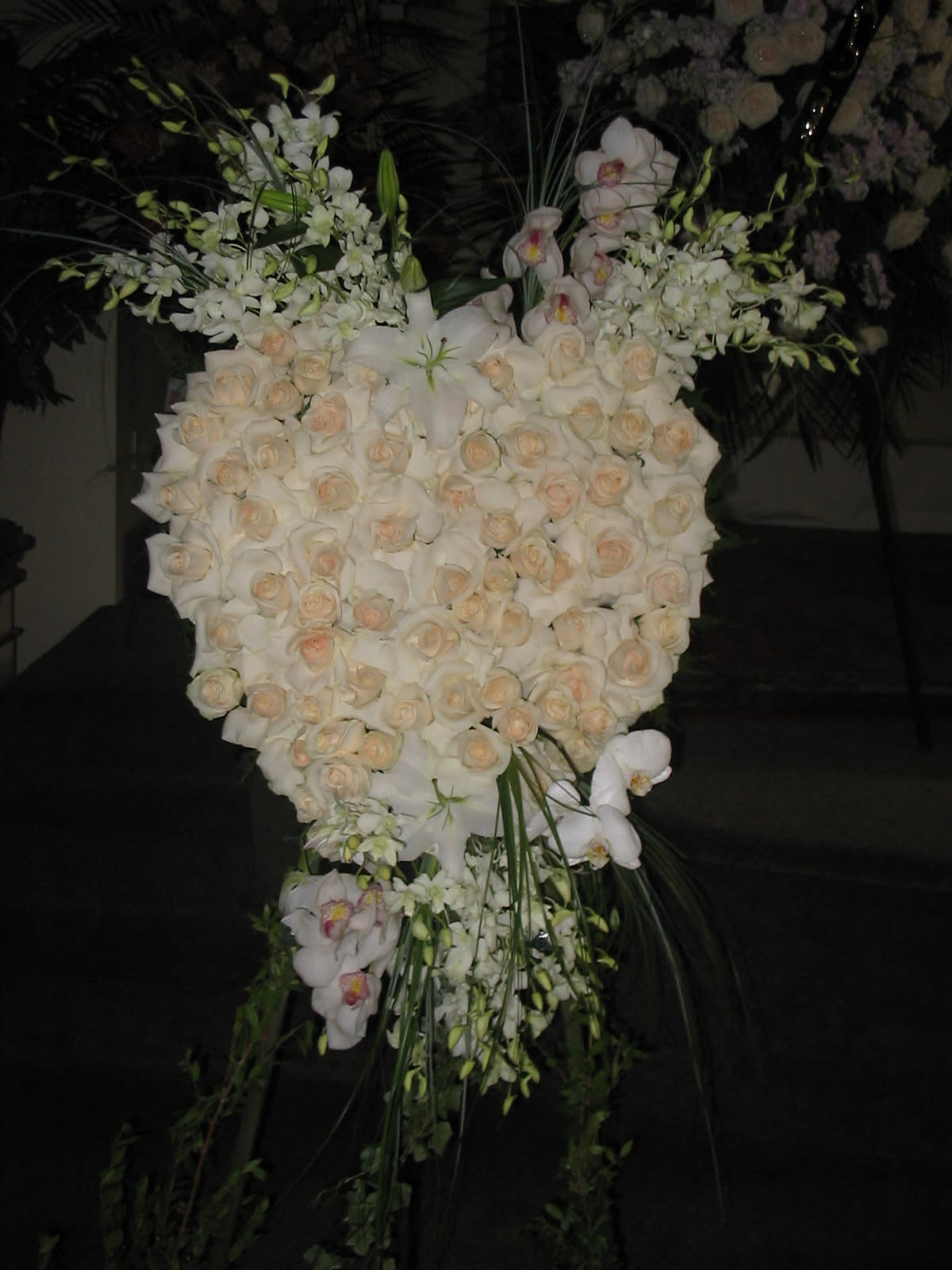 Large white floral standing spray with roses and orchids