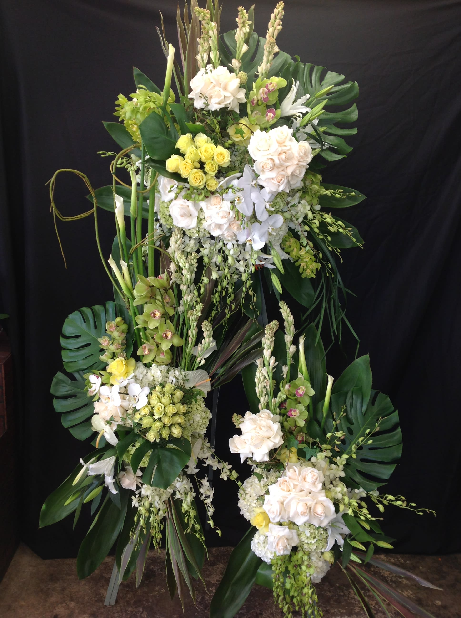 Tall floral standing arrangement with white and pale yellow blooms