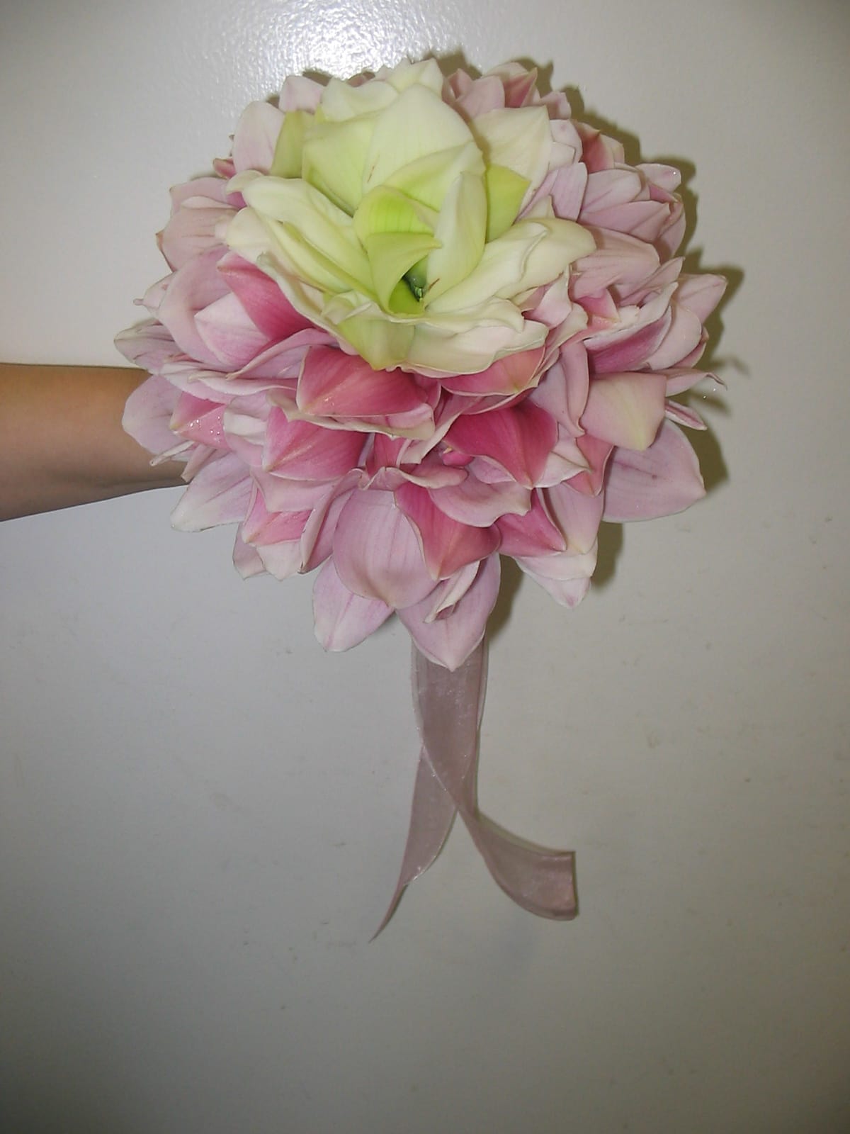 Pink and white flower bouquet with a ribbon handle