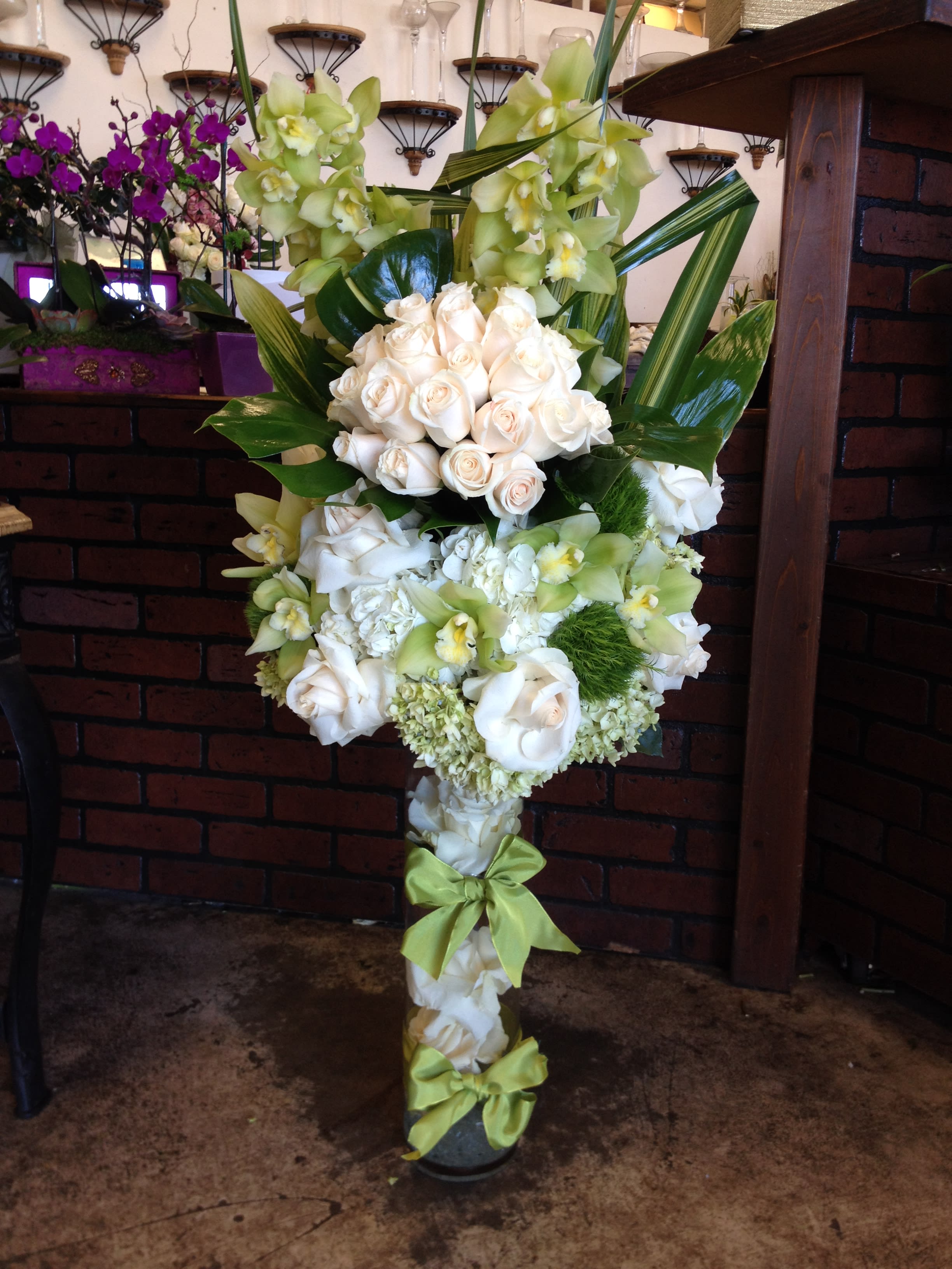 Tall floral standing spray with white roses and green orchids