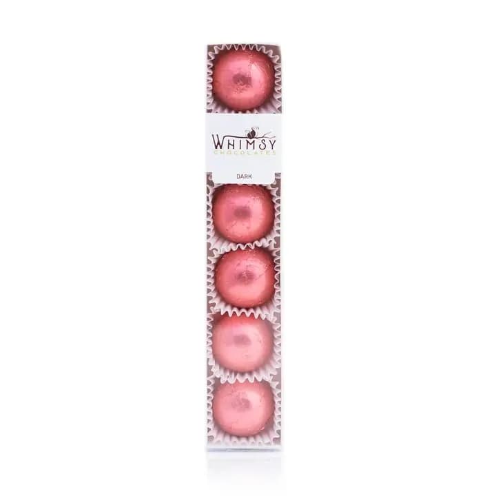 Box of pink chocolate truffles in individual cups