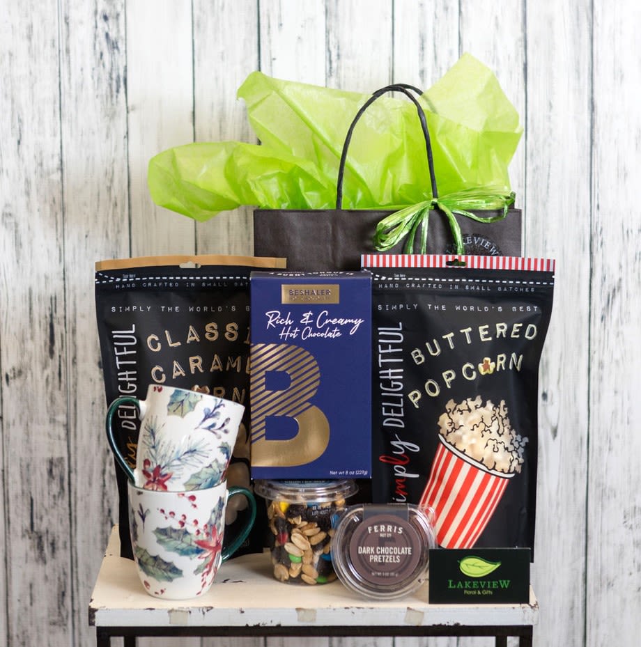 Gift basket with mugs, popcorn, hot chocolate, and chocolates