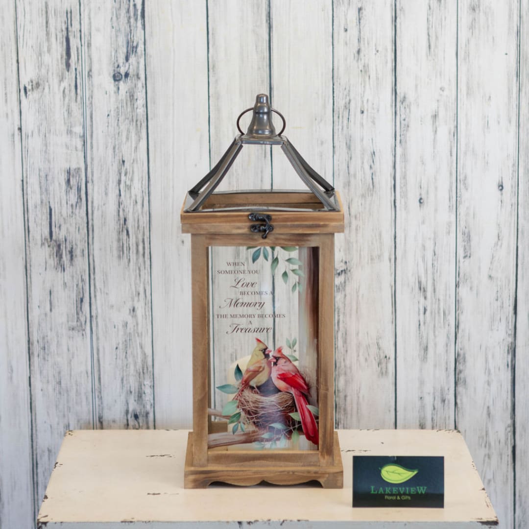 Wooden lantern with a memorial bird print inside