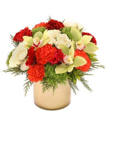 Round arrangement of red and white flowers with green orchids in a gold cylinder vase