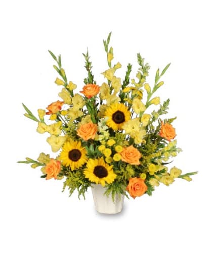 Tall yellow and orange flower arrangement with sunflowers and roses in a white container