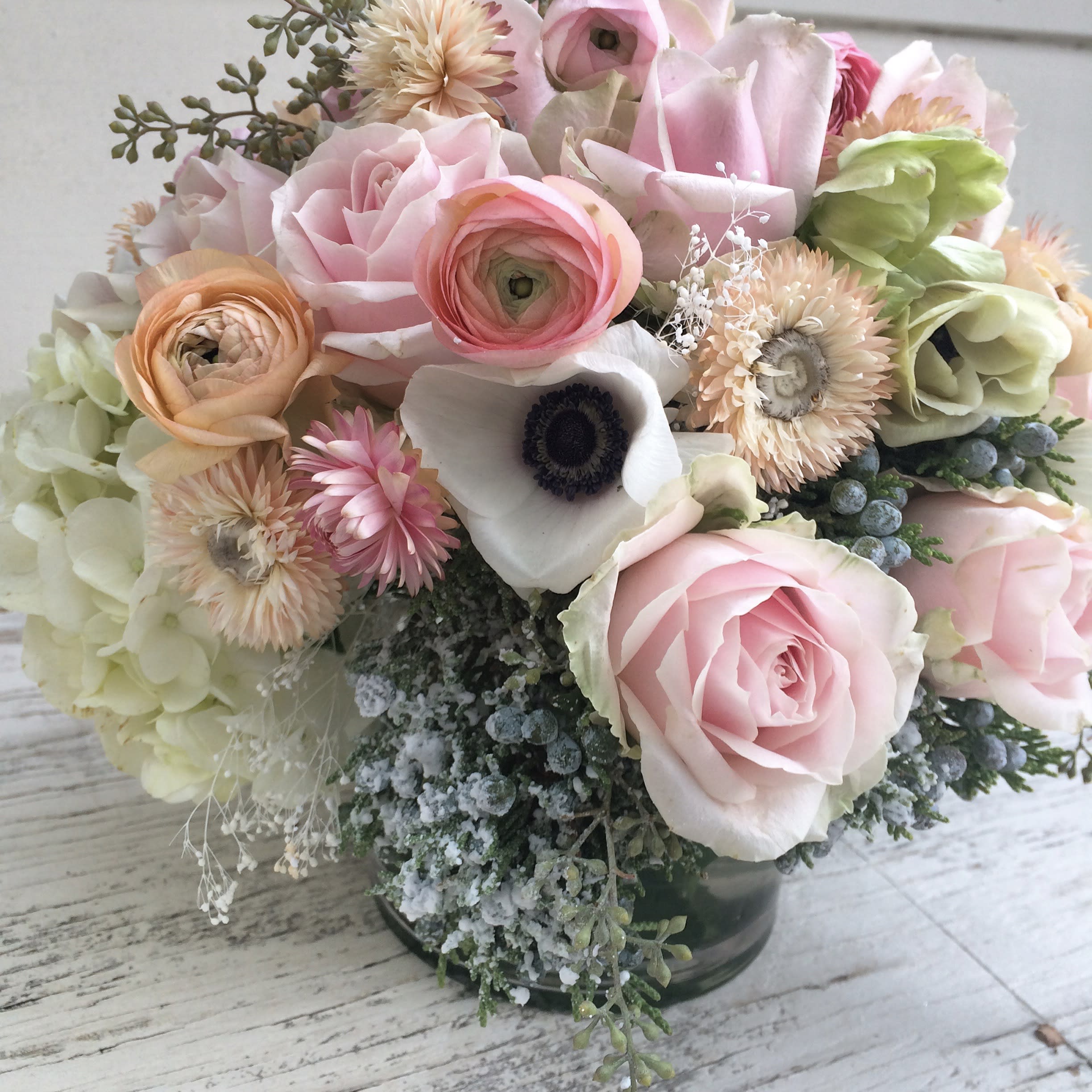 Winter pastels - Milky white, ivory, light pink, powder, cream and dusty greens with the odd accent of yellow in this dreamy winter arrangement. All the fresh blooms of high quality are arranged in a clear vase (5 by 5) and will please the recipient. A little "snow" is added here and there for a perfect winter feel. Blomst LA only uses fresh, high quality flowers, all carefully selected every day to fit your flower order. We offer a personal hand delivery by our own delivery staff and guarantee the flowers will look perfect, when they arrive. We deliver in Glendale, Pasadena, Eagle Rock, Hollywood, Burbank, Beverly Hills - and everywhere else in Greater Los Angeles.