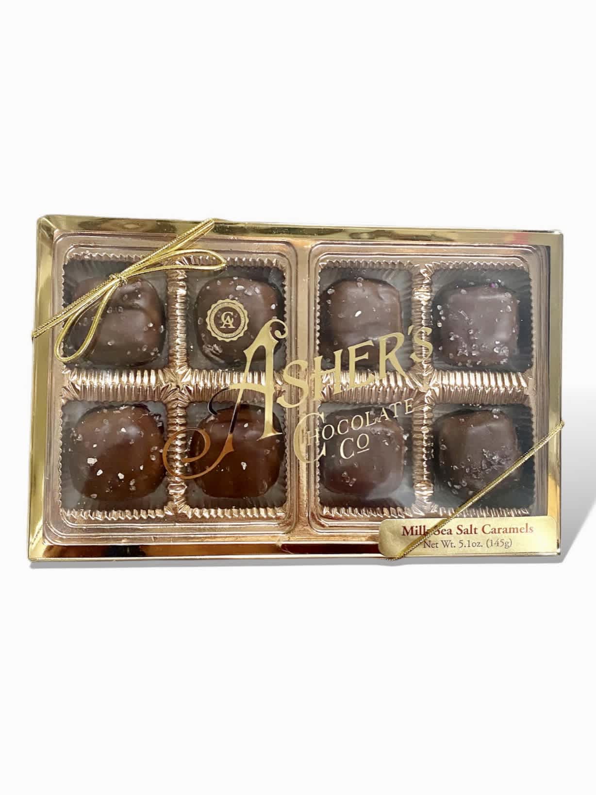 Box of chocolate sea salt caramels with a gold ribbon