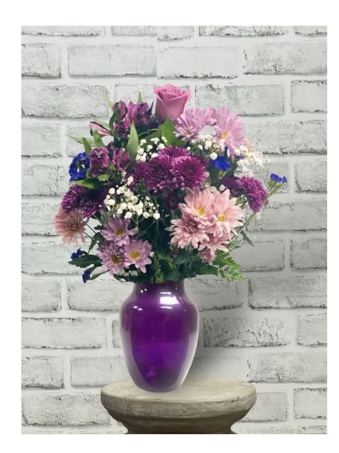Purple elegance vase - Know someone you love to make laugh? Someone you love to laugh with? Someone who could use a laugh? Someone who fits all of the above? Well, this beautiful arrangement has charms that extend way beyond its blossoms.