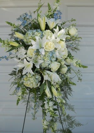 Tall white floral standing spray with lilies and roses