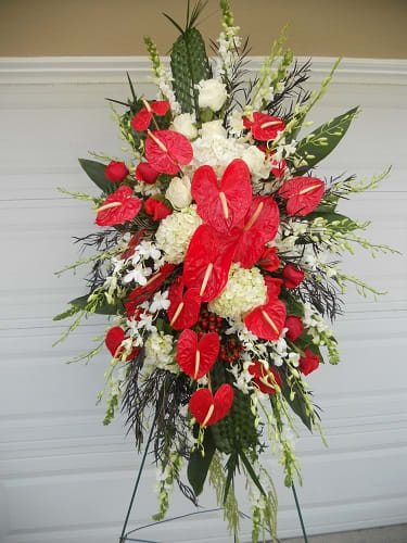 Tall standing spray with red anthuriums and white flowers