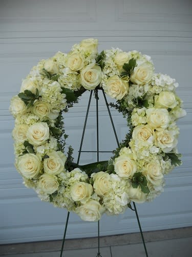 Cream rose and hydrangea wreath on a metal stand