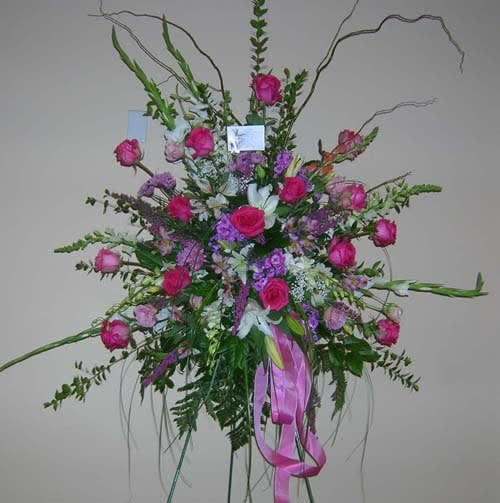 Tall pink and purple floral spray with ribbon accents