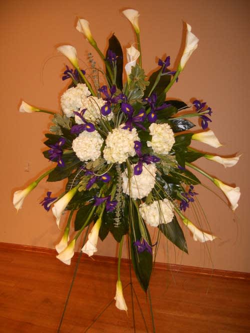 Tall floral standing spray with white calla lilies and purple flowers