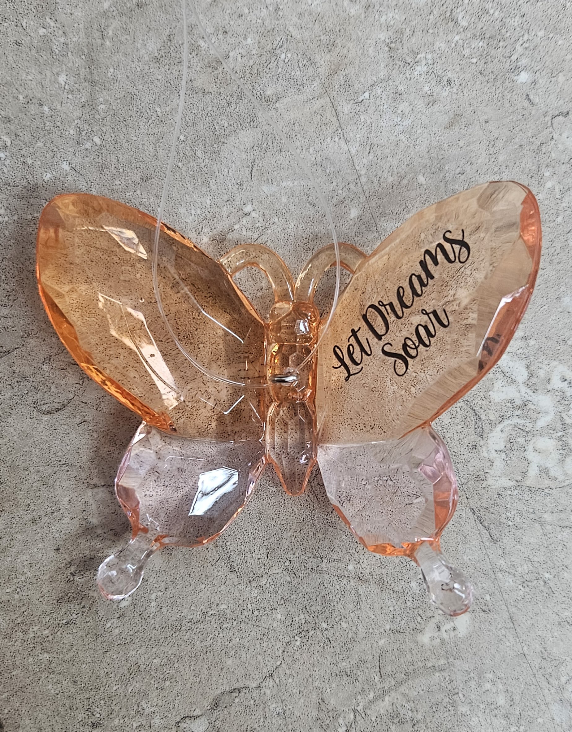 Butterfly-shaped decorative balloon with "Let Dreams Soar" text