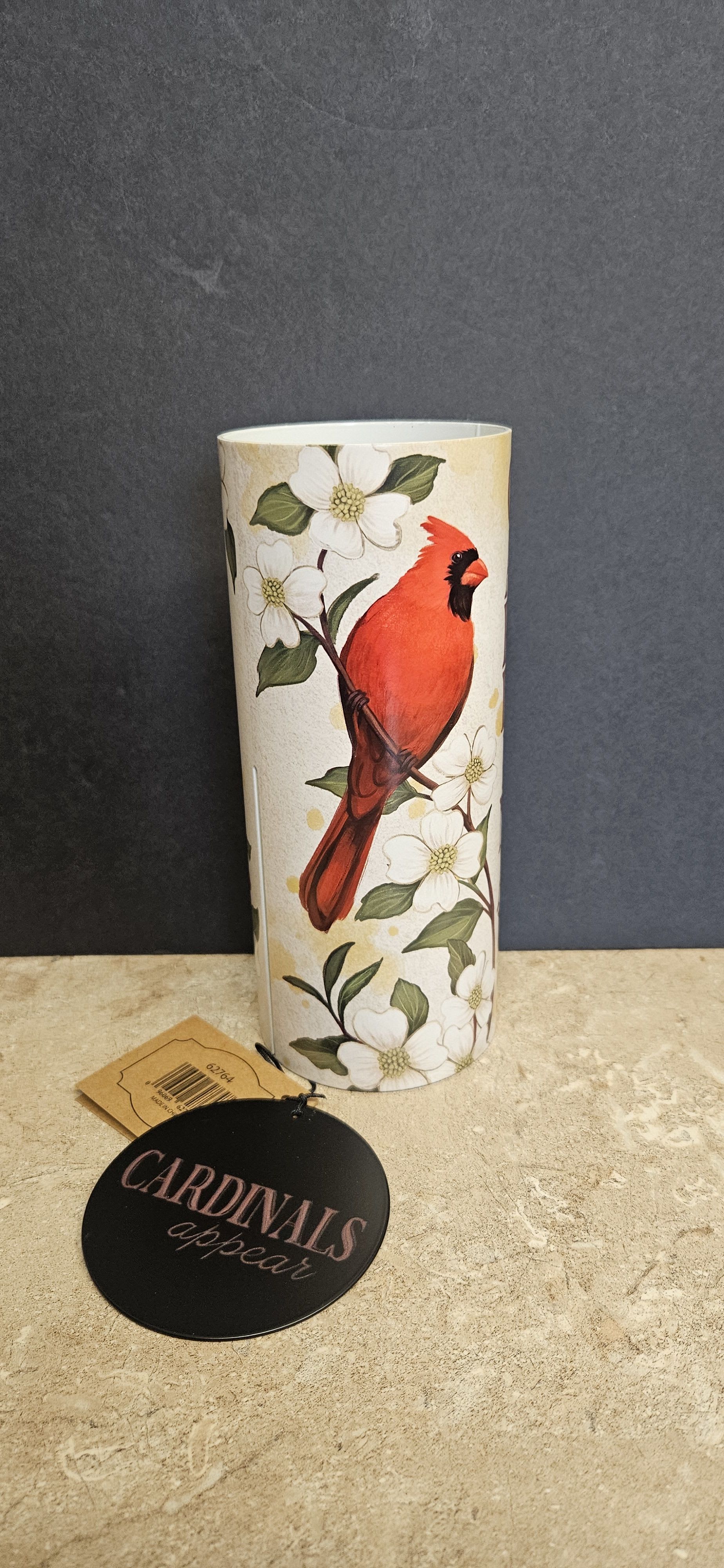 Tall cylindrical vase with a red cardinal and white flowers