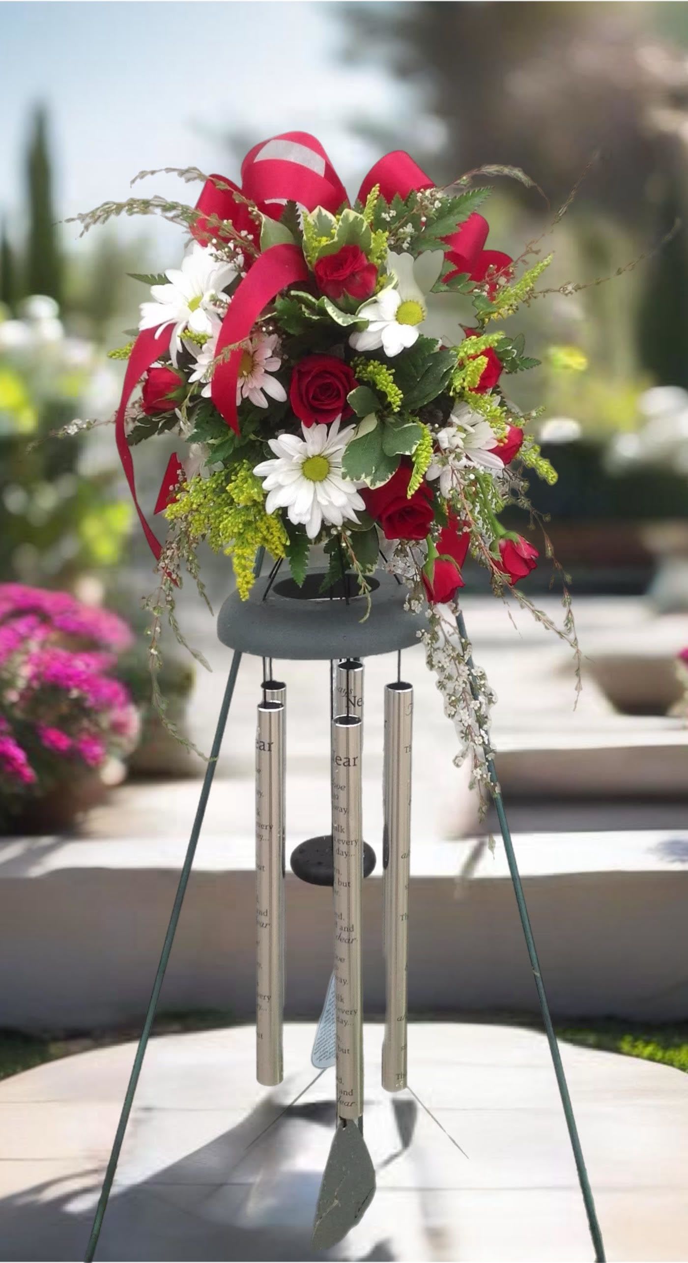 Red roses and white daisies in a hanging wind chime arrangement