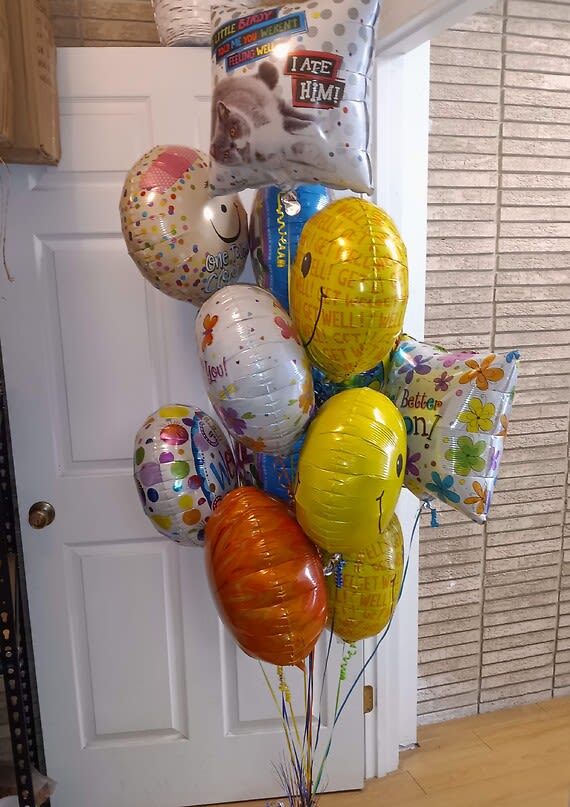 Cluster of colorful helium balloons with birthday and get-well messages