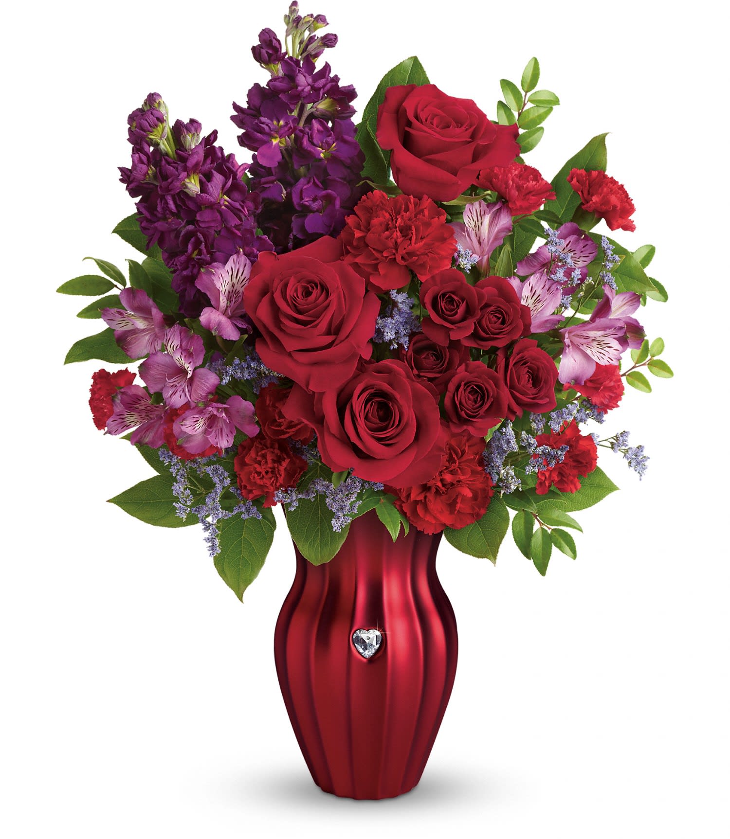 Teleflora's Shining Heart Bouquet - This radiant bouquet includes red roses, red spray roses, purple alstroemeria, red carnations, red miniature carnations, purple stock, accented with lavender limonium, huckleberry and lemon leaf. Delivered in a Shining Heart vase. Approximately 15 1/2" W x 19 1/2" H
