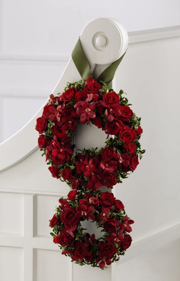 FTD Love's Eternity Pew Arrangement - The FTDÂ® Love's Eternityâ¢ Pew Arrangement is a simply stunning way to  decorate the church where you will take your wedding vows. Red spray  roses and red mokara orchids are accented with lush greens and arranged  in the shape of the eternity symbol. Meant to be hung from each pew with  a sage grosgrain ribbon, this arrangement will bring the color and  essence of love into the space for this special day. Approx. 20âH x  12âW.
