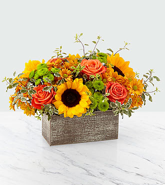 Sunflower and orange rose arrangement in a rectangular textured container