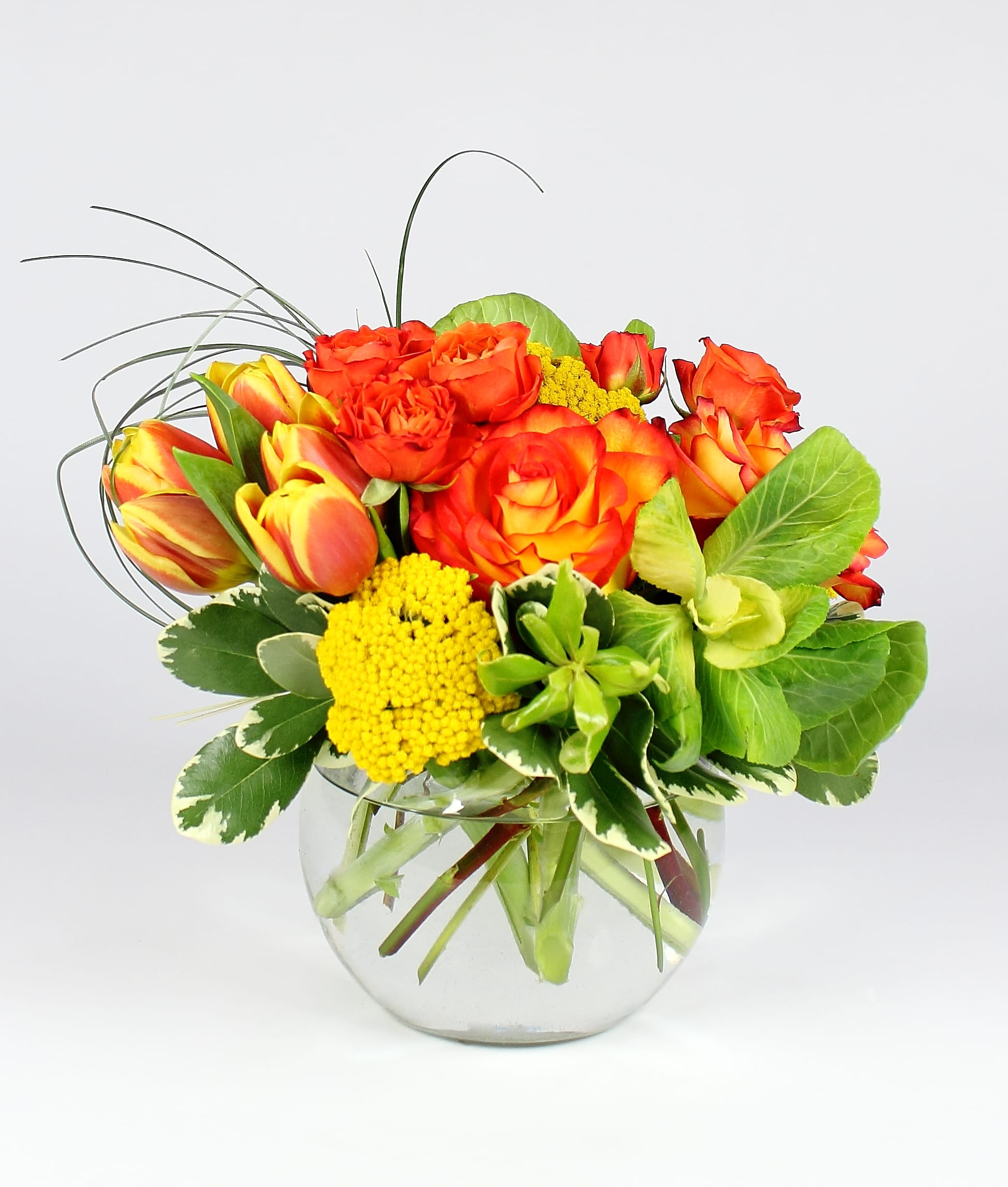 Orange and yellow rose bouquet in a clear glass vase
