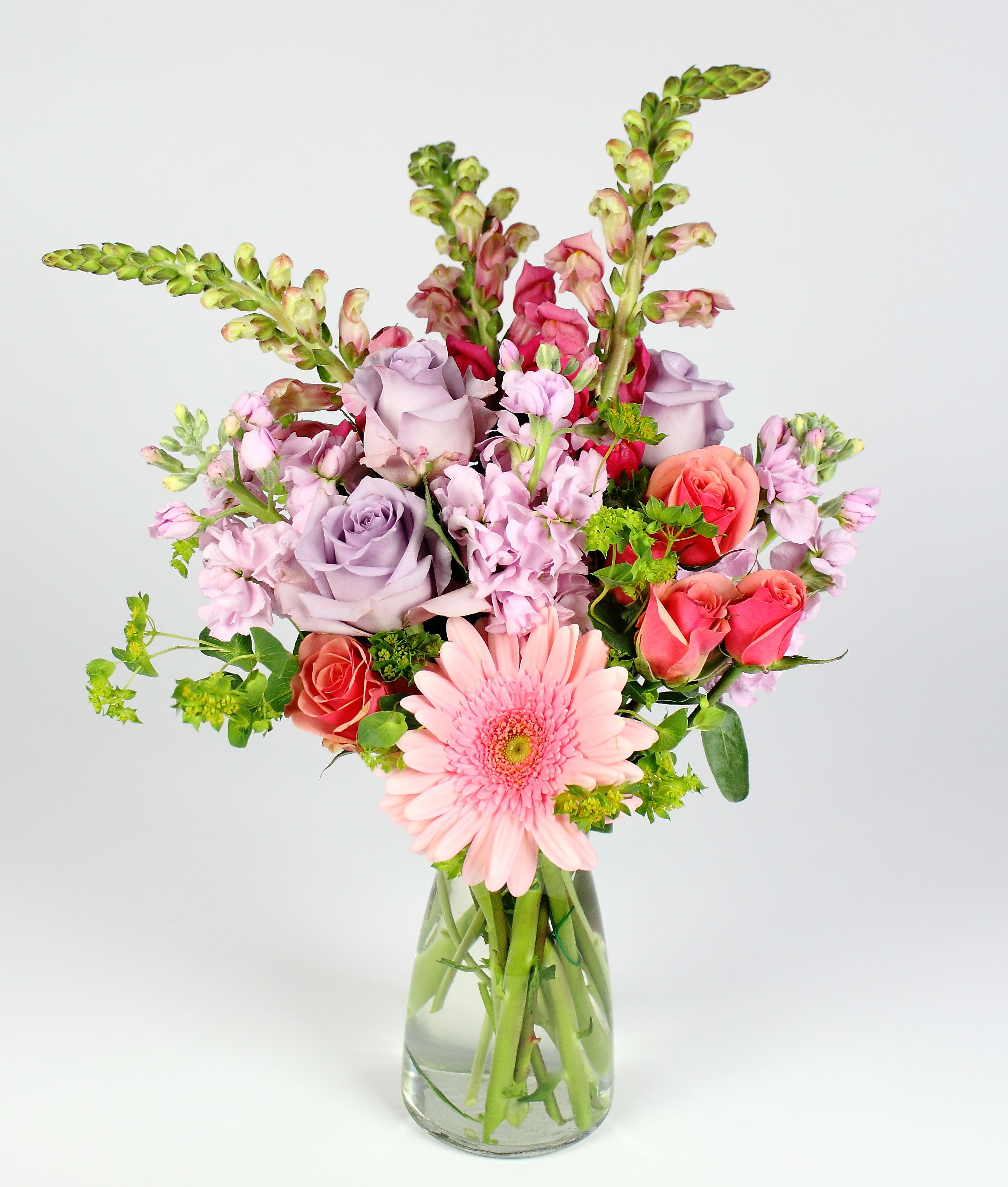 Pink and lavender mixed bouquet in a clear glass vase