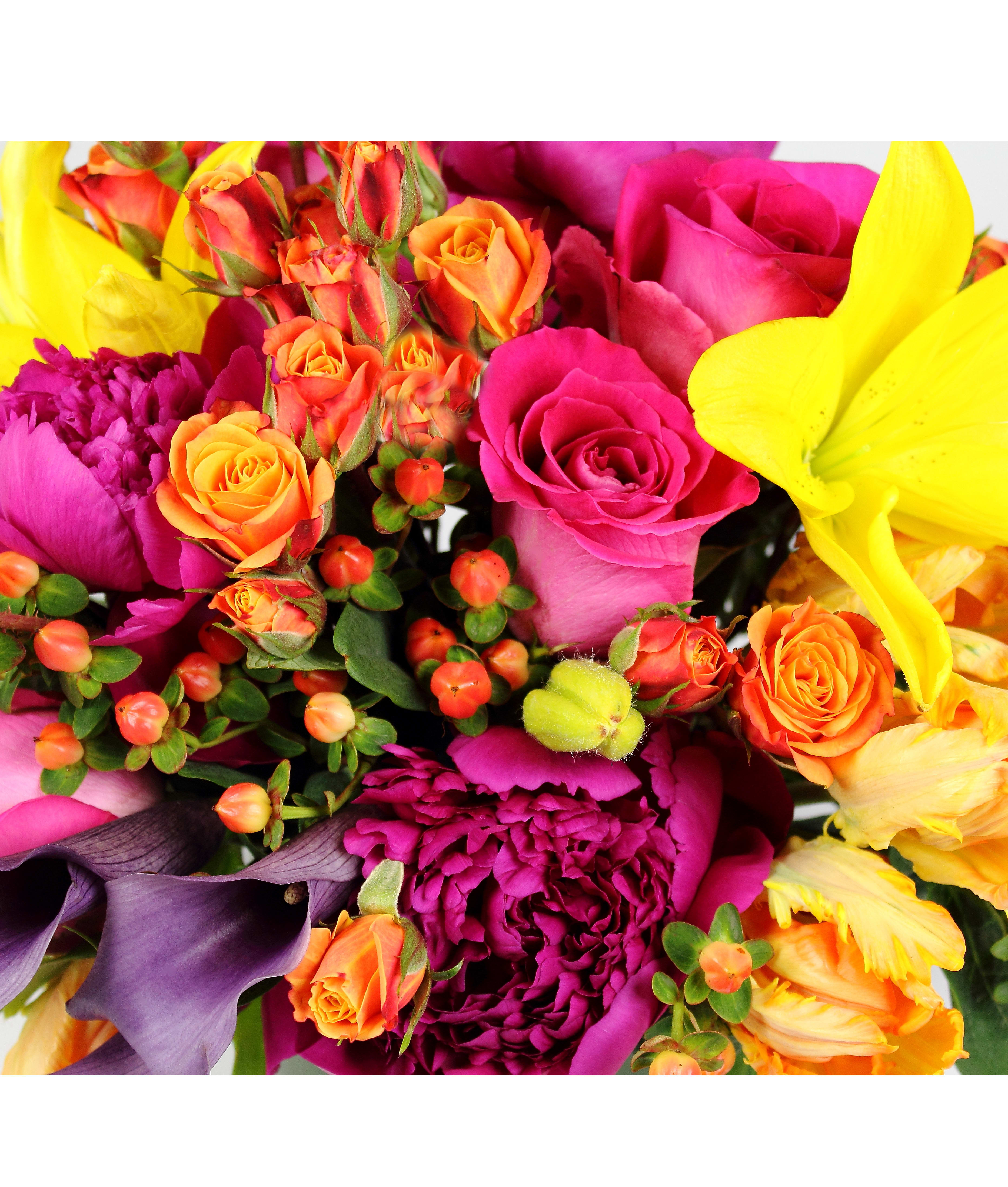 Bright mixed bouquet with pink roses, orange spray roses, and yellow lilies