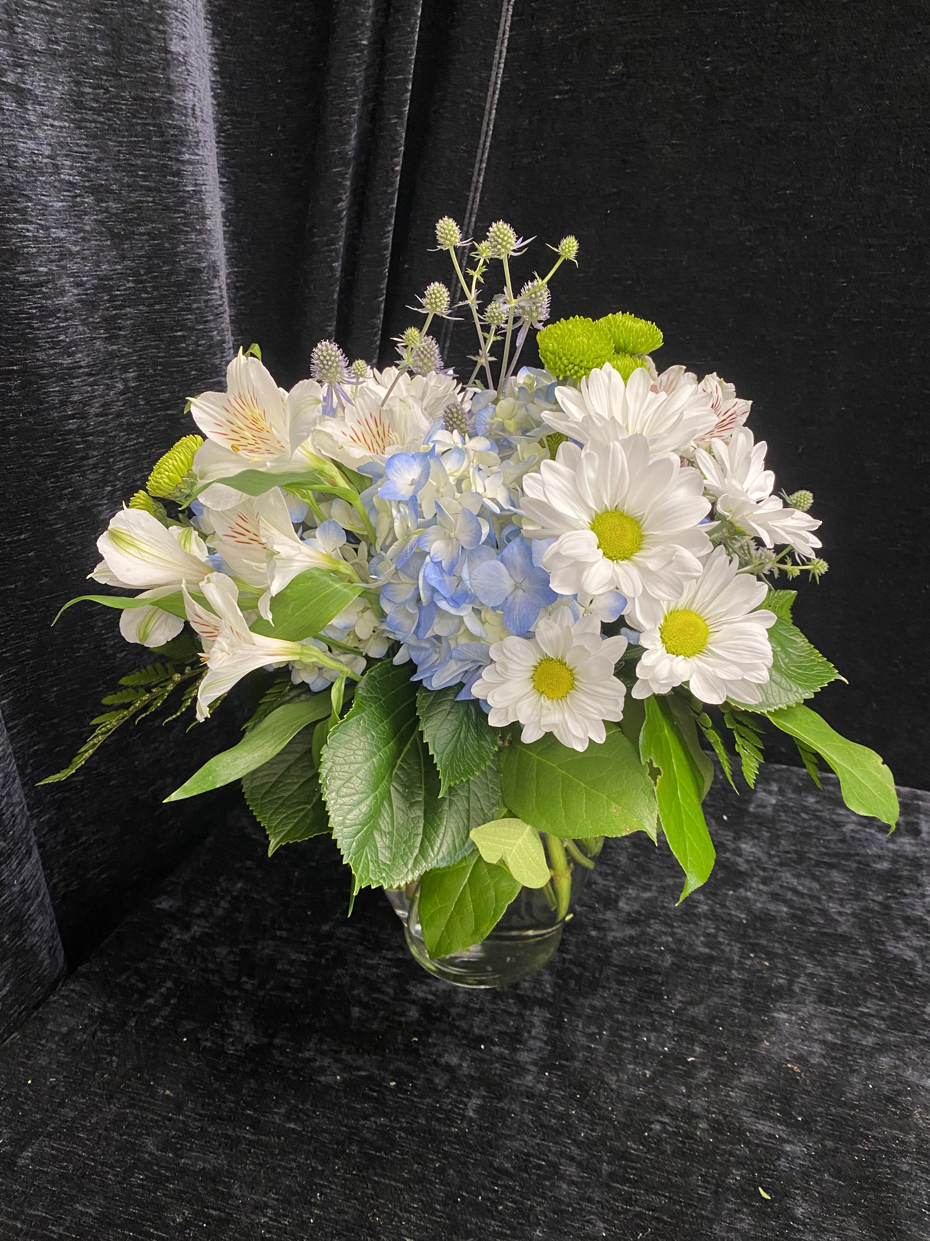 Baby Blues - Arrangement is created with Hydrangea, Alstromeria, Daisies, Pomps and Thistle. 