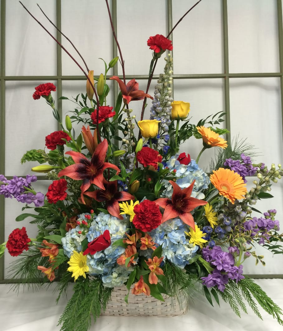 Colorful mixed flower arrangement in a woven basket
