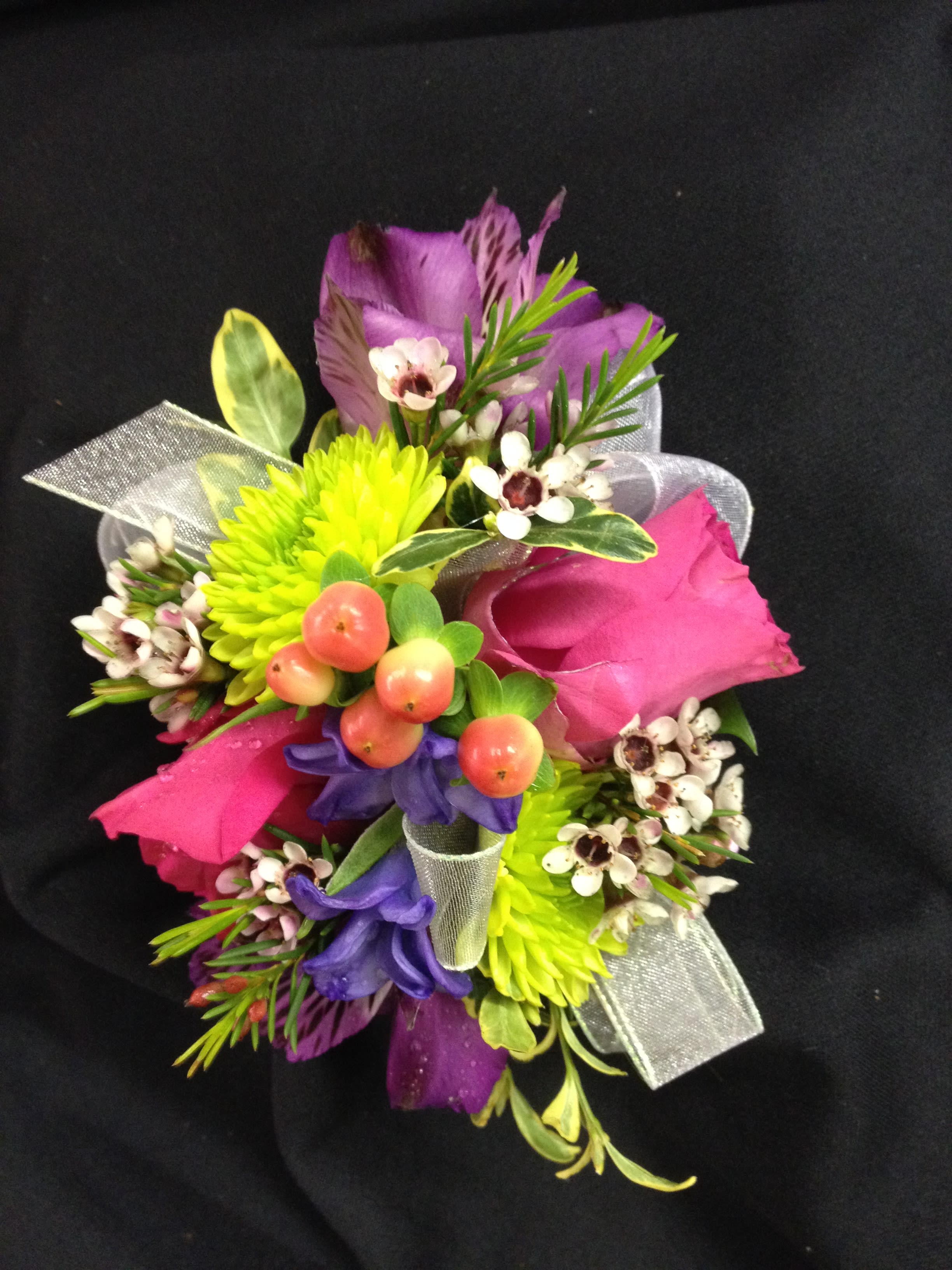 Colorful bouquet with pink roses, purple blooms, and lime-green flowers