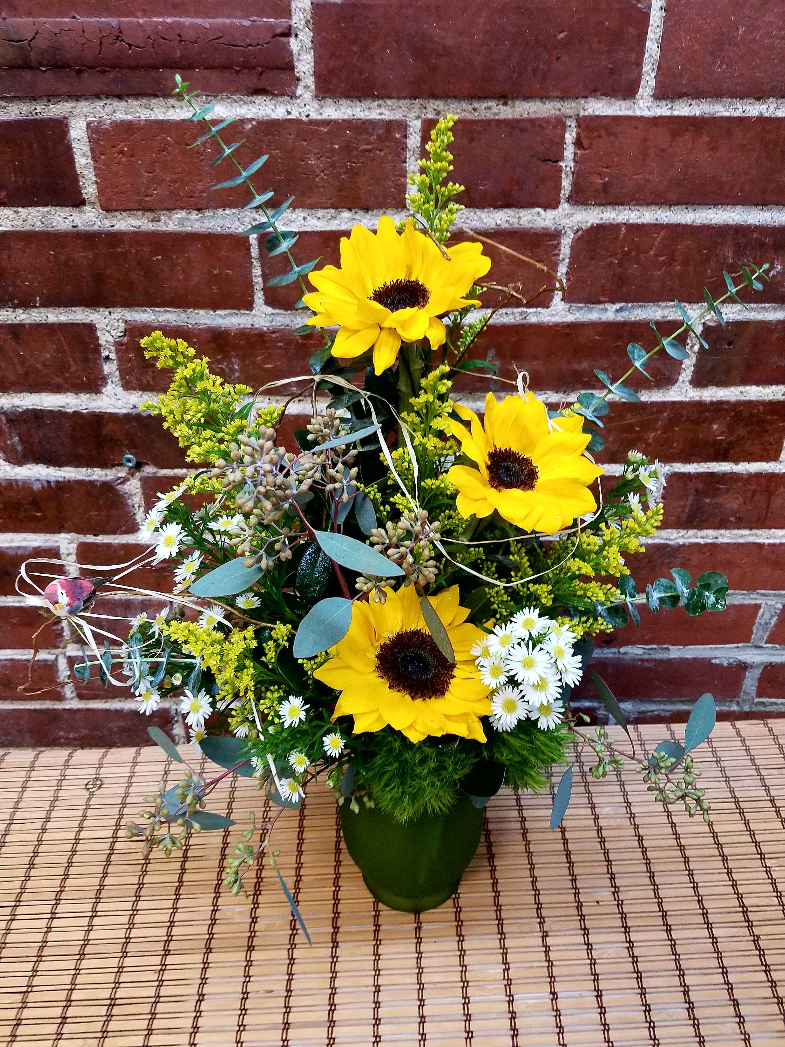 Eckert Florist's Sunny Sunflower Bouquet - This beautiful sunflower featured bouquet is sure to put a smile on anyone's face. *Vase style and color may vary 