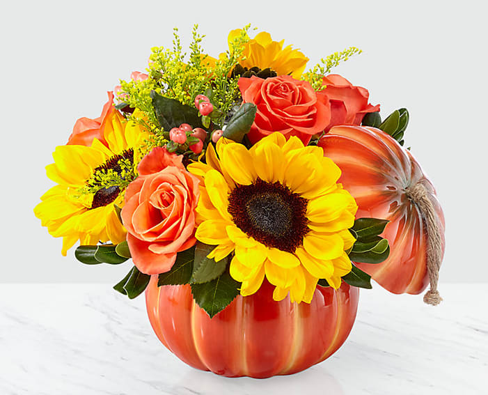 Eckert Florist's FTD Bountiful Bouquet - When you need to say everything and more, say it with the Bountiful Bouquet. An artful blend of sunflowers, roses and hypericum berries creates vibrant hues in one of our most remarkable bouquets. The blooms are arranged to perfection within a keepsake lidded ceramic pumpkin container. *Flowers and colors may vary.