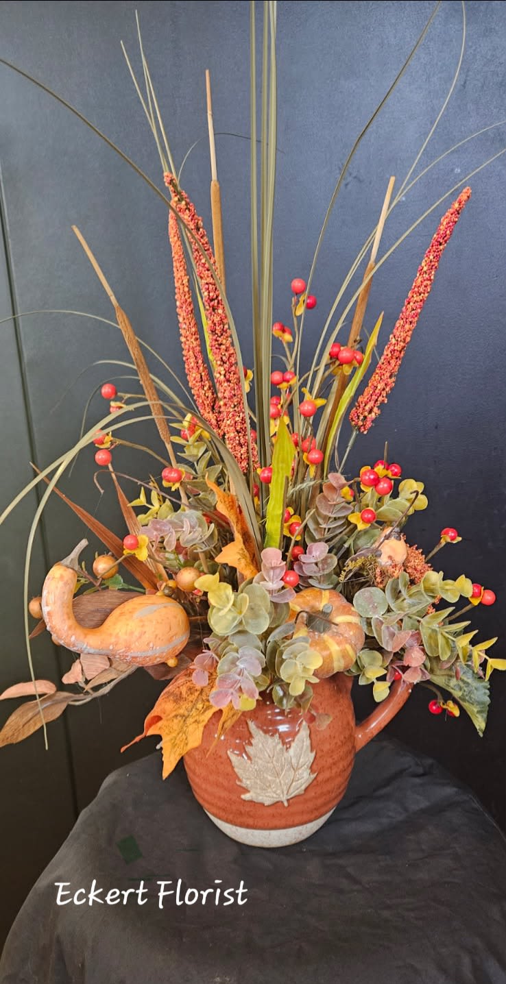Eckert Florist's Artificial Fall Pitcher Bouquet *Our Local Delivery Only - Fall ceramic pitcher artificial arrangement measures approx. 22" High x 14" Wide. *Our local delivery only