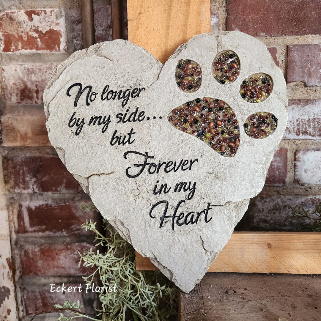 Heart-shaped memorial plaque with paw prints and a sympathy message