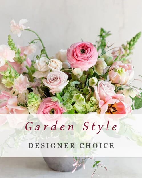 Pink and white mixed flower arrangement in a gray vase