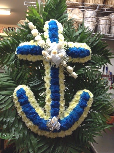 Blue and white floral cross wreath with white ribbon accents