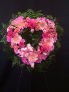 Heart-shaped pink floral wreath with a ribbon bow