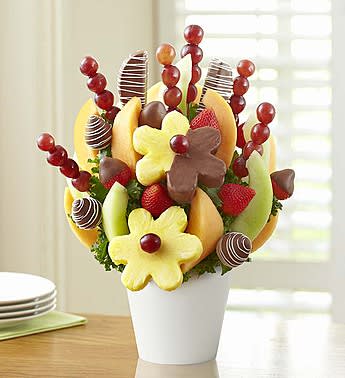 Fruit bouquet in a white vase with strawberries and chocolate-dipped fruit