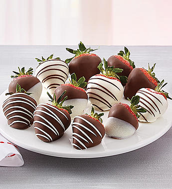 Plate of chocolate-covered strawberries with white drizzle